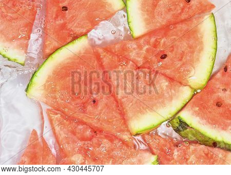 Slices Of Melon In Water On White Background. Melon Close-up In Liquid With Bubbles. Slices Of Red R
