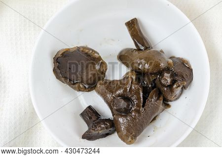 Unsuitable Marinated Mushrooms In A White Ceramic Bowl.spoiled Homemade Pickled Suillus. Food Poison