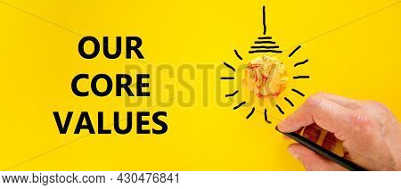 Our Core Values Symbol. Businessman Writing Words 'our Core Values', Isolated On Beautiful Yellow Ba