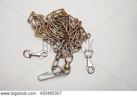 An Iron Chain And Three Different Carbines On A White Background