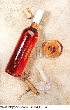 Rose Wine Glass With Bottle On The Beige Table. Copy Space, Top View