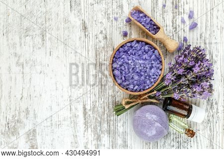 Lavender's Spa Products With Dried Lavender Flowers On A Wooden Table. Flat Lay Bath Salt And Massag