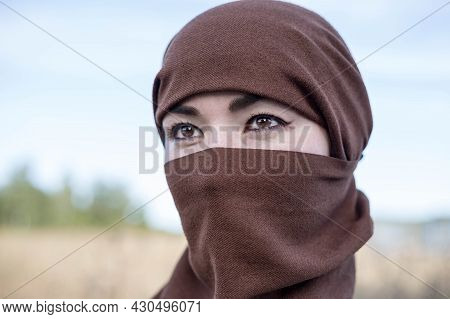 An Afghan Woman In A Hijab, Close-up. The Seizure Of Power. The Taliban.
