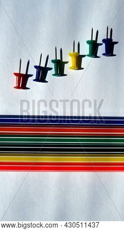 Colored Pencils And Stationery Buttons On A White Background