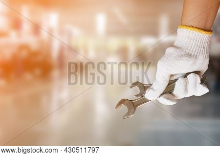 Mechanic Holding Pair Of Wrench At Car Servicing Centre
