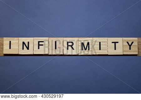 Text On Word Infirmity From Gray Wooden Letters On A Black Background
