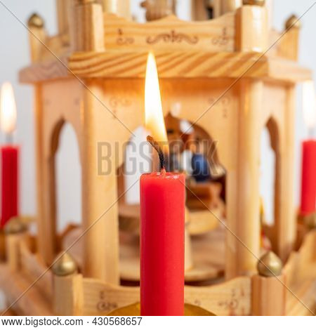 Burning Candles At The Christmas Pyramid. High Quality Photo