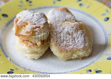 Fried Fritters Sifted By Sugar Powder On Plate