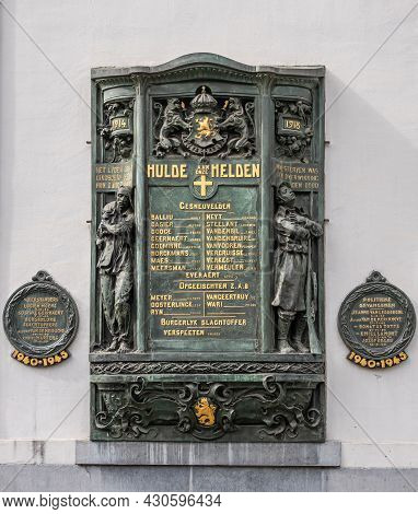 Gent, Flanders, Belgium - July 30, 2021: Gold On Green Bronze Fresco Againt White Wall Of House In G
