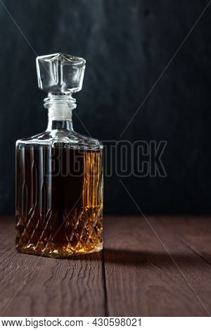 Vintage Jar With Alcohol. It Can Be Whiskey, Cognac, Brandy, Sherry Or Calvados On Wooden Table In D