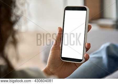 Young Woman Hands Holding Cell Phone With Mockup White Blank Display, Empty Screen For App Ads At Ho