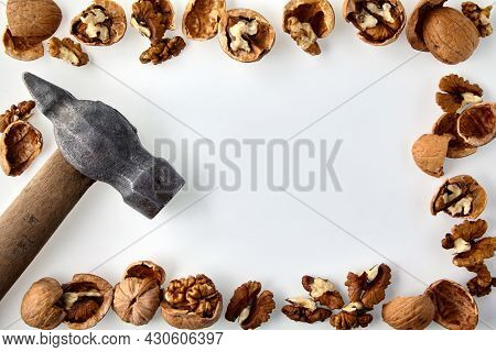 A Frame Made Of Chopped Walnuts And A Hammer