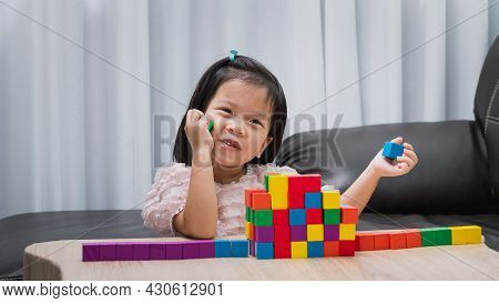 Little Child Plays On Warm Floor Using Colorful Wooden Blocks. Build Railway And Train Station Accor