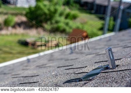 Residential Asphalt Shingle Roof With Metal Anchors Installed For The Installation Of A Solar Panel 