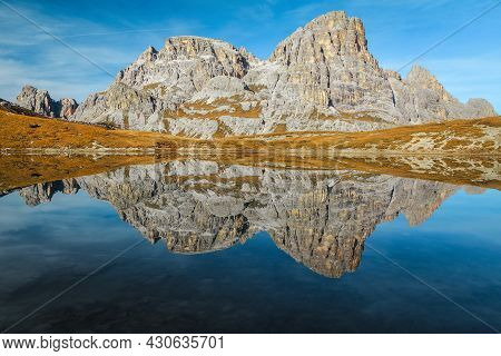 Alpine Autumn Scenery With Beautiful Mountain Lake Lago Dei Piani. Spectacular Mountain Peaks Reflec