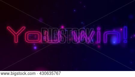 Image of you win text in flickering neon letters over blue and red spotlights. Global network of connection and image game concept digitally generated image.