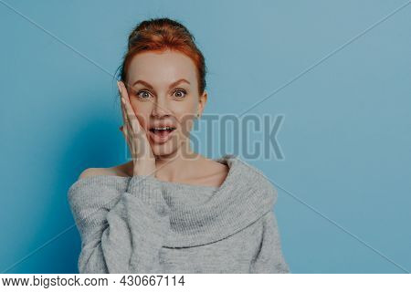 Portrait Of Surprised Amazed Red Haired Woman Looking At Camera With Impressed Face Expression, Feel