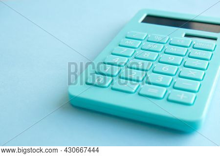 Mint Calculator, Notebook And Pen On Blue Background