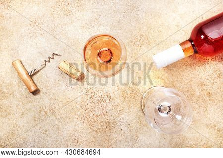 Rose Wine Glass With Bottle On The Beige Table. Copy Space, Top View