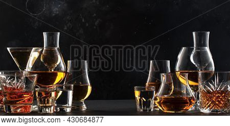 Strong Alcohol Drinks, Hard Liquors, Spirits And Distillates Iset In Glasses: Cognac, Scotch, Whiske