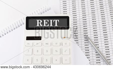 Calculator With Text Reit On Notebook . Business, Finance Conceptual.