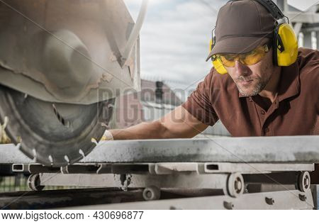 Concrete Outdoor Path Tile Cutting By Professional Caucasian Worker Wearing Safety Glasses. Outdoor 
