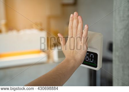 Women Hand Checking Temperature Before Entering Cafe With Digital Automatic Body Measuring Temperatu