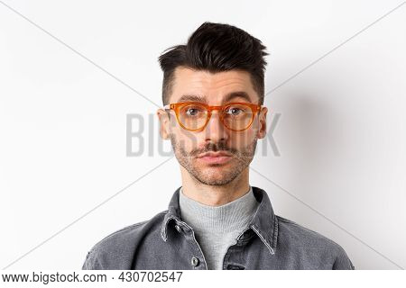 Attractive Brunette Man With Moustache, Wearing Stylish Glasses And Look Serious At Camera, No Emoti