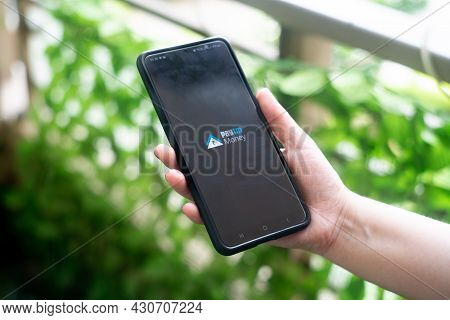 Young Indian Woman Holding A Phone With Paytm Money Logo Allowing For Investments Direct Mutual Fund