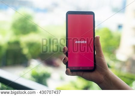 Hand Holding A Mobile Phone With Zomato App Logo Showing This Food Tech Startup Unicorn That Has Rec