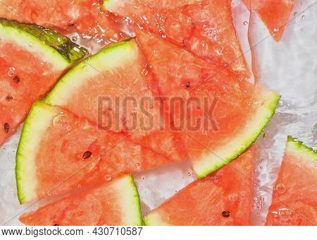 Melon Close-up In Liquid With Bubbles. Slicec Of Red Ripe Melon In Water. Close-up Fresh Slices Of R