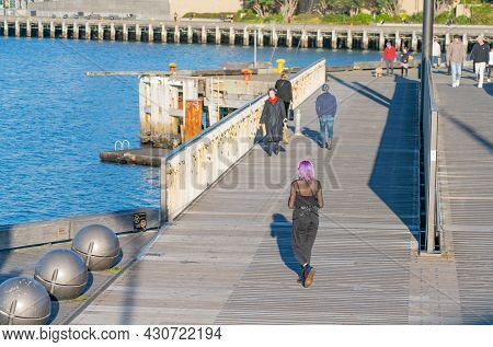 Wellington New Zealand - July 30 2021;hip Girl With Bright Purple Hair Walking Away And Others Walki