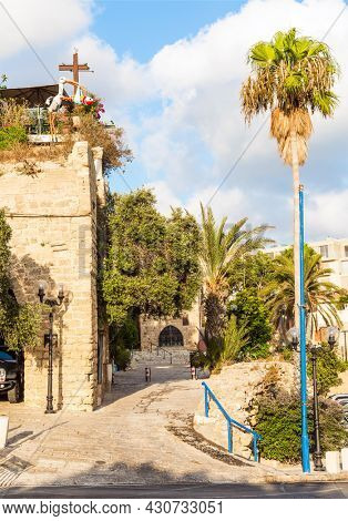 Old Yaffo - one of the most ancient cities of the world. Warm summer evening. Century masonry walls. Doors bound by metal bars. Sunset. Concept active, informative and photo of tourism