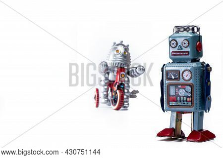 Vintage Tin Toy Robots On White Background With Copyspace