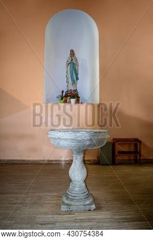 Shkoder, Albania - June 21, 2021: Virgin Mary Statue And Marble Water Bowl In St Stephen's Catholic 