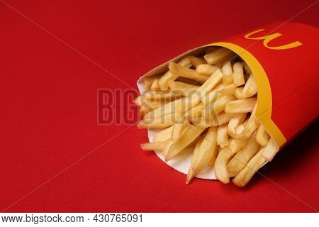 Mykolaiv, Ukraine - August 12, 2021: Big Portion Of Mcdonald's French Fries On Red Background, Close