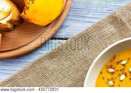 Pumpkin Soup On A Wooden White Table Top View. Helovin Holiday