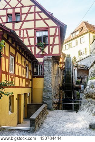 Water Mill In Meersburg, Germany. Vertical View Of Old Half-timbered Houses And Medieval Mill Wheel.