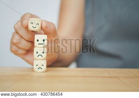 Senior Human Hand Selected Happy Face Wood Cube And Others On Green Background For Customer Service 