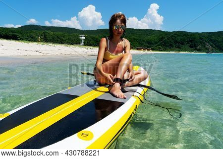 Happy Woman Surfer Putting On Equipment For Sup Surfing Paddle At Sea Nature Scenery Exotic Resort