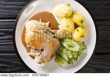 Danish Fried Old-fashioned Chicken With Boiled Potatoes And Cucumber Salad Close-up In A Plate On Th