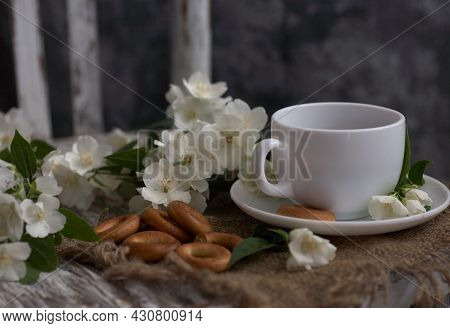 Cup Of Tea With Jasmine Flowers On A Vintage Chair