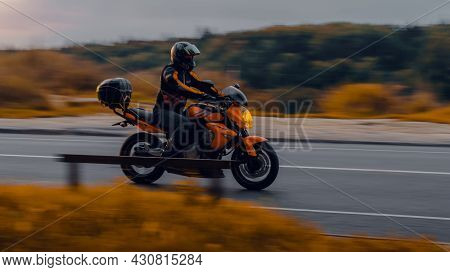 Motorcycle Kawasaki Er-6n In Motion On The Country Road In Evening. Side View Of Man Riding Motorbik