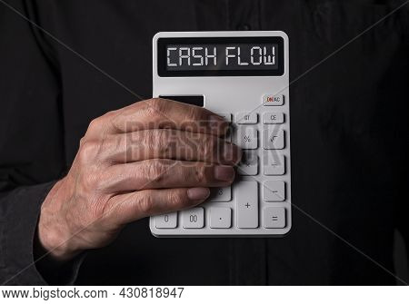 Hand Holding Calculator With Cah Flow Words As Concept Of Black Illegal False Cashflow.