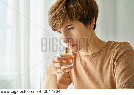 Caucasian Woman Inhaling Aroma Of Perfume Bottle. Loss Of Smell Due To Coronavirus. Concept Of Long-