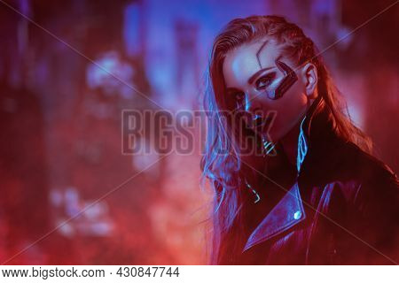 Cyberpunk concept. Technology and fashion. A beautiful cyberpunk girl stands against the backdrop of the night city of the future. 