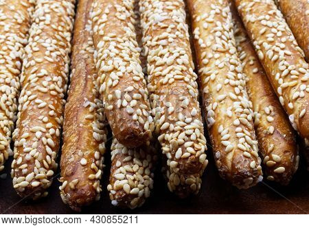Sesame Breadsticks (grissini Al Sesamo) Close Up Isolated On Wooden Table