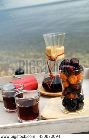 Outdoor Brewing Coffee Served On A Tray Table. Dried Fruit In Layers In A Glass Beaker. Water Landsc
