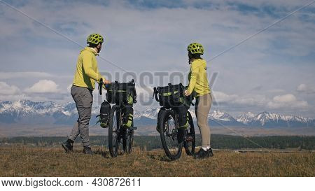 The Man And Woman Travel On Mixed Terrain Cycle Touring With Bikepacking. The Two People Journey Wit