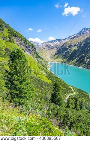Vivid Blue Mountain Lake In Summer Alps. Speicher Zillergrundl Dam, Zillertal Alps, Austria
